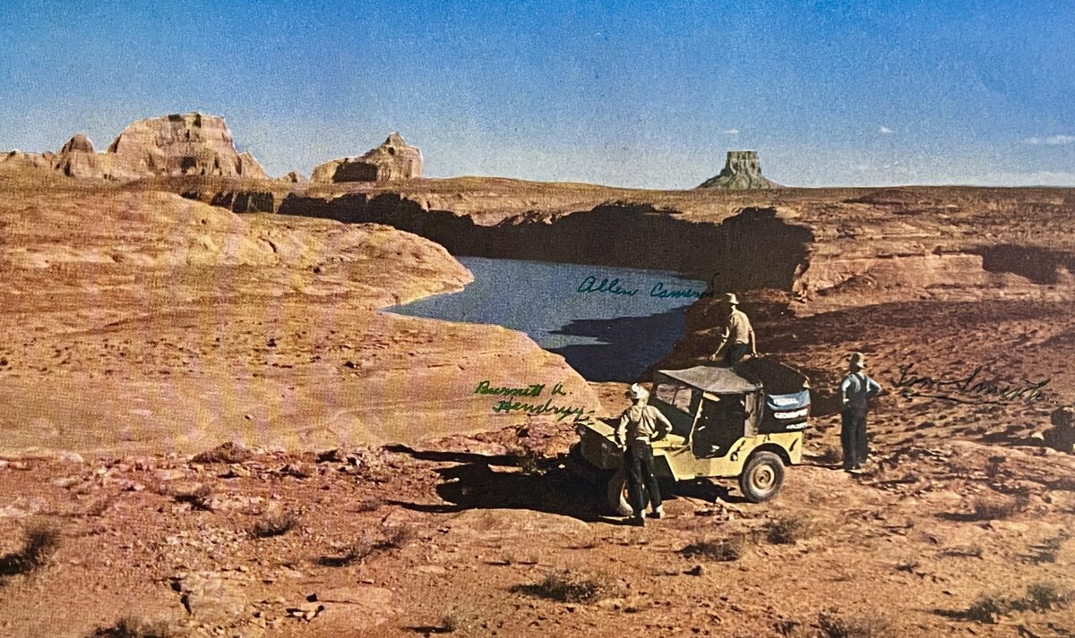 Vintage desert expedition with jeep overlooking canyon and water